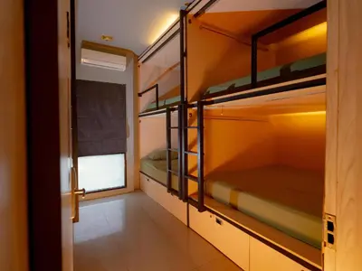 a room with four bunk beds in it at Kuta Cube Hostel in Kuta