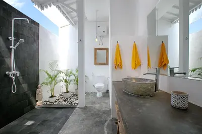 a bathroom with a bath tub and a sink at Villa Mertanadi - Cosy 2bdrs in center Kerobokan - popular district in Seminyak