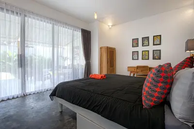 a bedroom with a bed and a large window at Villa Mertanadi - Cosy 2bdrs in center Kerobokan - popular district in Seminyak