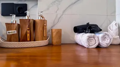 a group of towels and toiletries on a wooden floor at Seminyak Loft 360 Private Pool Villas in Seminyak