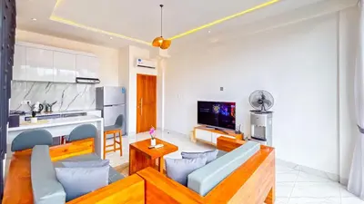 a living room with a couch and a kitchen at Seminyak Loft 360 Private Pool Villas in Seminyak