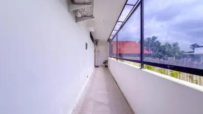 an empty hallway of a building with a large window at Seminyak Loft 360 Private Pool Villas in Seminyak