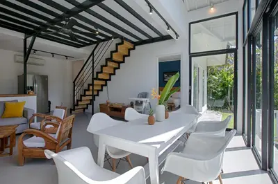 a dining room with a white table and white chairs at Villa Pepita - Cosy 3bdrs villa, family friendly - Seminyak in Badung
