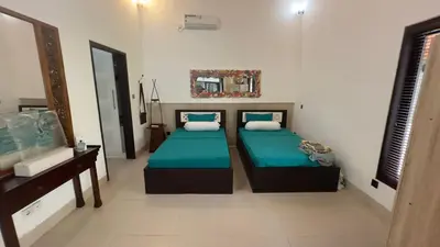 a bedroom with two beds and a fish tank at Villa Casa Jamika in Seminyak
