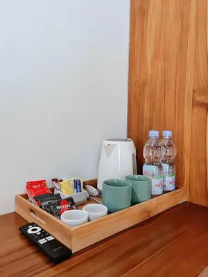 a wooden tray with food and drinks on a table at Rove Pool Villa Seminyak in Seminyak