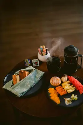 a table with a plate of food on a table at The Casa Amaya By Puri Asia in Jimbaran