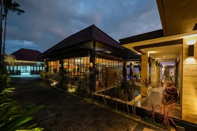 a building with a fence in front of it at night at The Casa Amaya By Puri Asia in Jimbaran