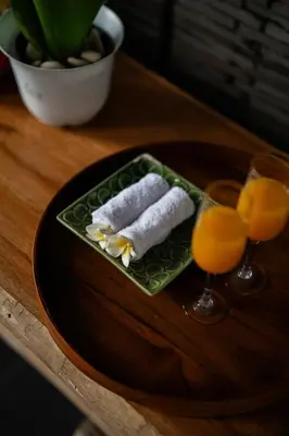 a plate with two sushi and two glasses of orange juice at The Casa Amaya By Puri Asia in Jimbaran
