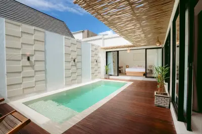 a swimming pool in the backyard of a house at Villa Tirtha at Nara Villa in Seminyak