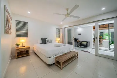 a bedroom with a bed and a living room at Paradise in the Heart of Seminyak! in Seminyak