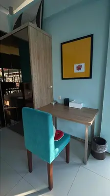 a desk with a blue chair and a wooden table at Bougenvilla Nusa Dua Villa with Private Pool in Nusa Dua