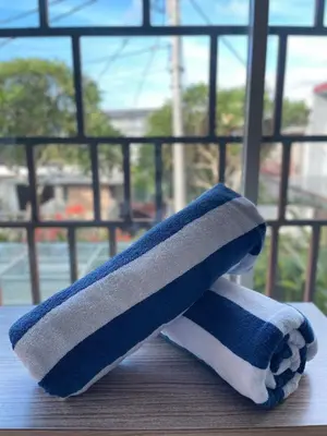 a towel sitting on a table next to a window at Bougenvilla Nusa Dua Villa with Private Pool in Nusa Dua