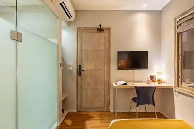 a room with a desk and a door and a chair at Cove Renata in Seminyak