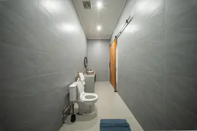 a bathroom with a toilet and a sink at Modern and Quiet 2BR Villa in Seminyak Central with Private Pool in Denpasar