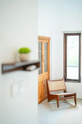 a living room with a chair and a window at Modern and Quiet 2BR Villa in Seminyak Central with Private Pool in Denpasar