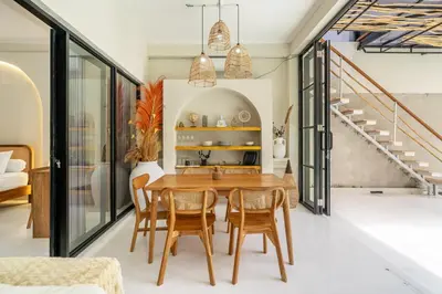a dining room with a wooden table and chairs at Villa Ocean Bali in Seminyak