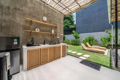 an outdoor kitchen with a sink and a patio at Villa Ocean Bali in Seminyak