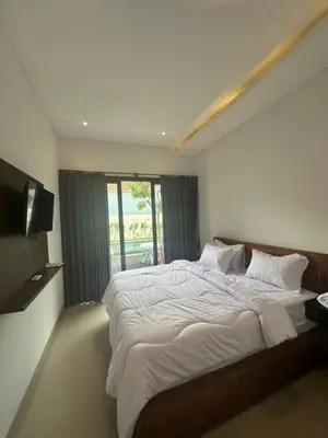 a bedroom with a large bed and a window at bali thousand island living - guest house in Pesanggaran