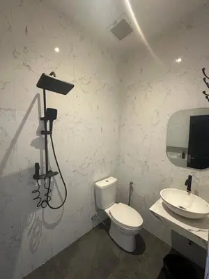 a bathroom with a toilet and a sink at bali thousand island living - guest house in Pesanggaran