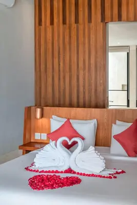a bed with a swan made out of pillows at Beachfront Escape Villa in Ujung