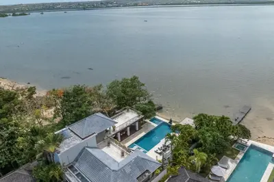 an aerial view of a house next to the water at Beachfront Escape Villa in Ujung