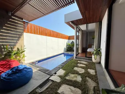 an external view of a house with a swimming pool at Ozzy Bali Villa 3 in Seminyak