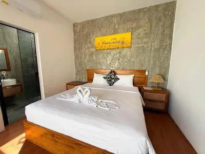 a bedroom with a bed with two bows on it at Ozzy Bali Villa 3 in Seminyak
