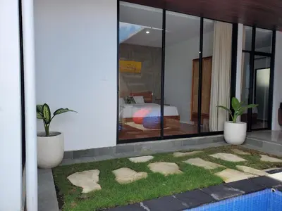 a house with a garden with rocks in the yard at Ozzy Bali Villa 3 in Seminyak