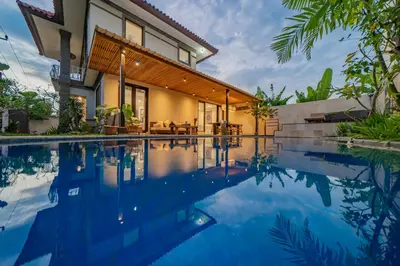 a house with a swimming pool in front of it at Adamo villa Seminyak in Seminyak