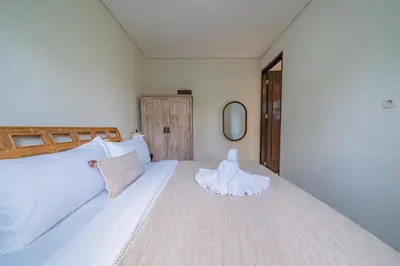 a bedroom with a large white bed in a room at Adamo villa Seminyak in Seminyak