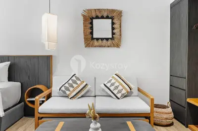 a living room with a couch and a mirror at Aranya by Kozystay - Nusa Dua in Nusa Dua