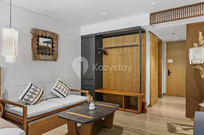 a living room with a couch and a table at Aranya by Kozystay - Nusa Dua in Nusa Dua