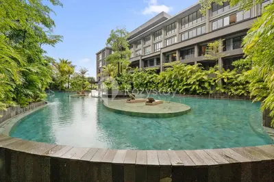 a large swimming pool in front of a building at Aranya by Kozystay - Nusa Dua in Nusa Dua