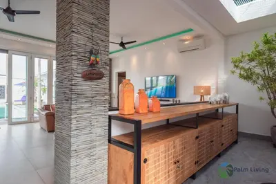 a room with a counter with orange vases on it at Villa Babar in Canggu