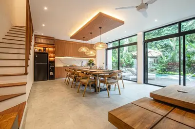 a kitchen and dining room with a table and chairs at Stylish 5BR Designer Villa, 400m to the Ocean in Canggu