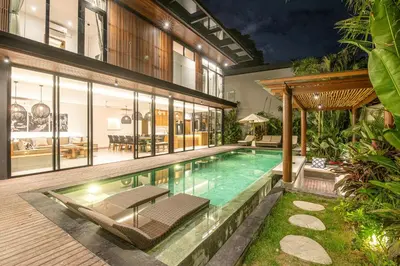 an indoor swimming pool in a house at Elegant 5BR Tropical Escape Just 400m to Beach in Canggu