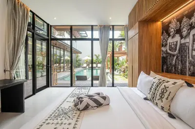 a bedroom with a large bed and a pool at Elegant 5BR Tropical Escape Just 400m to Beach in Canggu