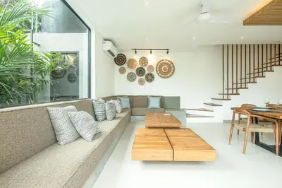 a living room with a couch and a table at Elegant 5BR Modern Villa Steps from Café Del Mar in Canggu