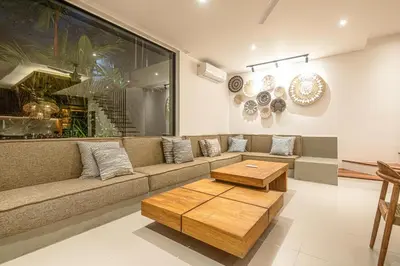 a living room with a couch and a coffee table at Elegant 5BR Modern Villa Steps from Café Del Mar in Canggu