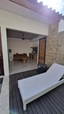 a white bed sitting on top of a wooden deck at NOWACs SASADARA in Canggu