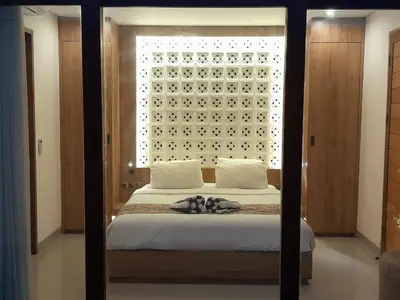 a bedroom with a bed with a large window at NOWACs SASADARA in Canggu