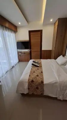 a bedroom with a large bed in a room at NOWACs SASADARA in Canggu