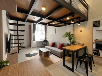 a living room with a couch and a table at De Kamar Mezzanine in Denpasar