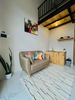 a living room with a couch and a table at Persada Loft Bali in Seminyak