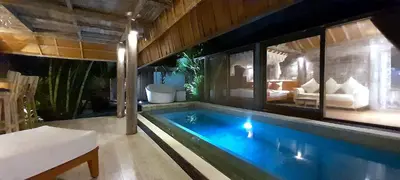 a swimming pool in a house with a living room at PROMO Private Vacation Rental Villa 2 Pools 4 Bedrooms 4 Bathroom Free Airport Pickup in Denpasar