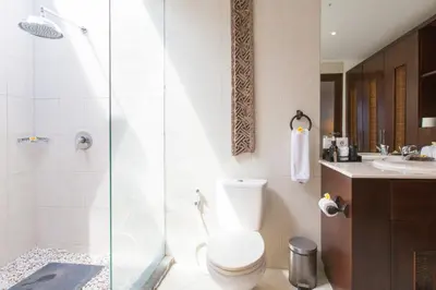 a bathroom with a shower and a toilet and a sink at Villa Sedap Malam Seminyak by Best Deals Asia Hospitality in Seminyak