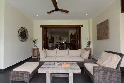 a living room with a white couch and a coffee table at Villa Balidamai in Kerobokan