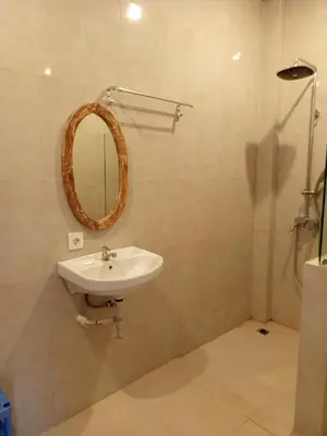 a bathroom with a sink and a mirror on the wall at Erick house in Seminyak