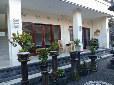 a group of potted plants on the porch of a house at Erick house in Seminyak