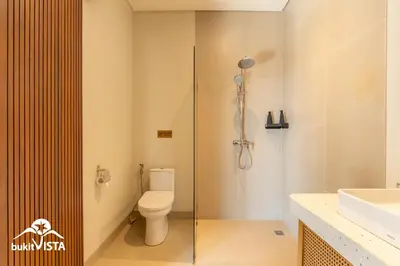 a bathroom with a shower and a toilet and a sink at Serayu Berawa by Bukit Vista in Canggu